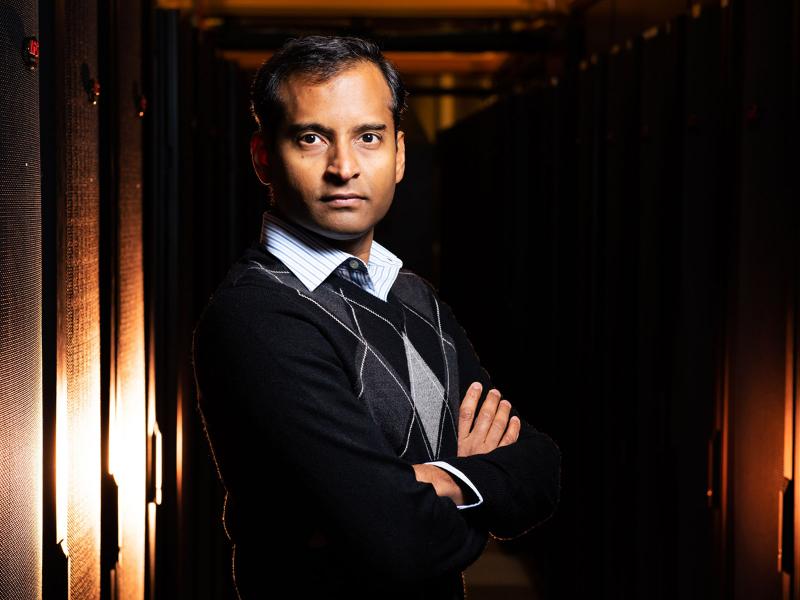 Sriram Krishnamoorthy posing with a supercomputer