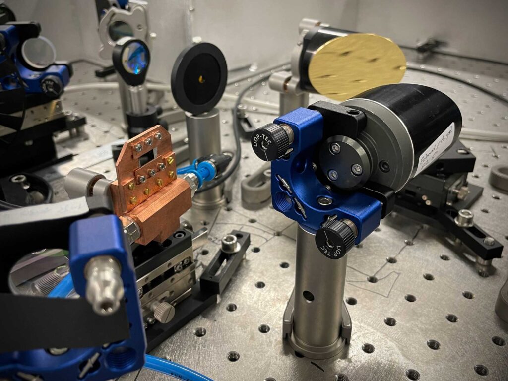 The semiconductor nanosheets in the water-cooled copper mount turn an infrared laser pulse into an effectively unipolar terahertz pulse. The team says that their terahertz emitter could be made to fit inside a matchbox. Image credit: Christian Meineke, Huber Lab, University of Regensburg